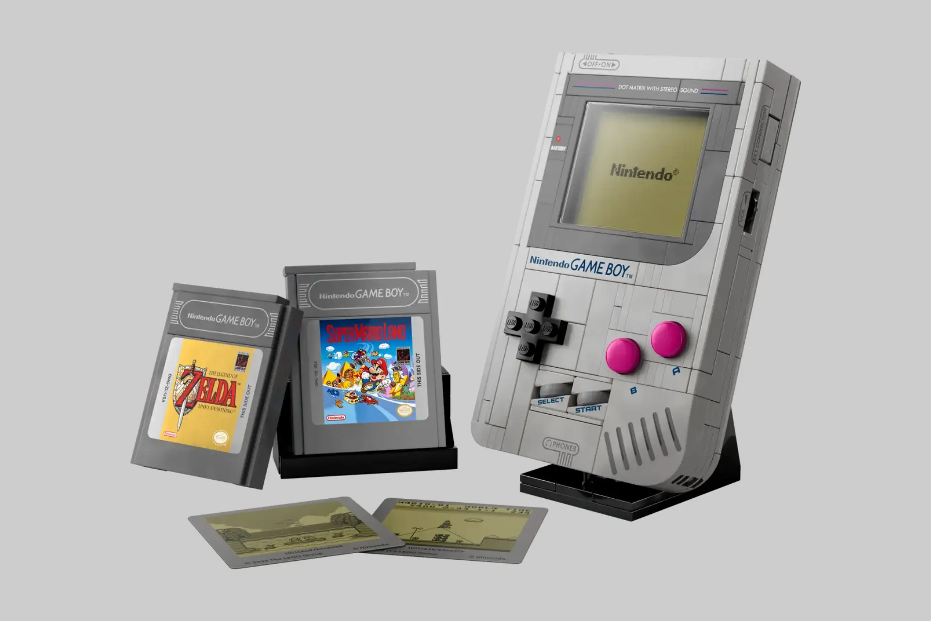 A close-up of the Lego Game Boy (72046) set on its display stand, showcasing the screen, functional buttons, and an inserted game cartridge. - Product Review