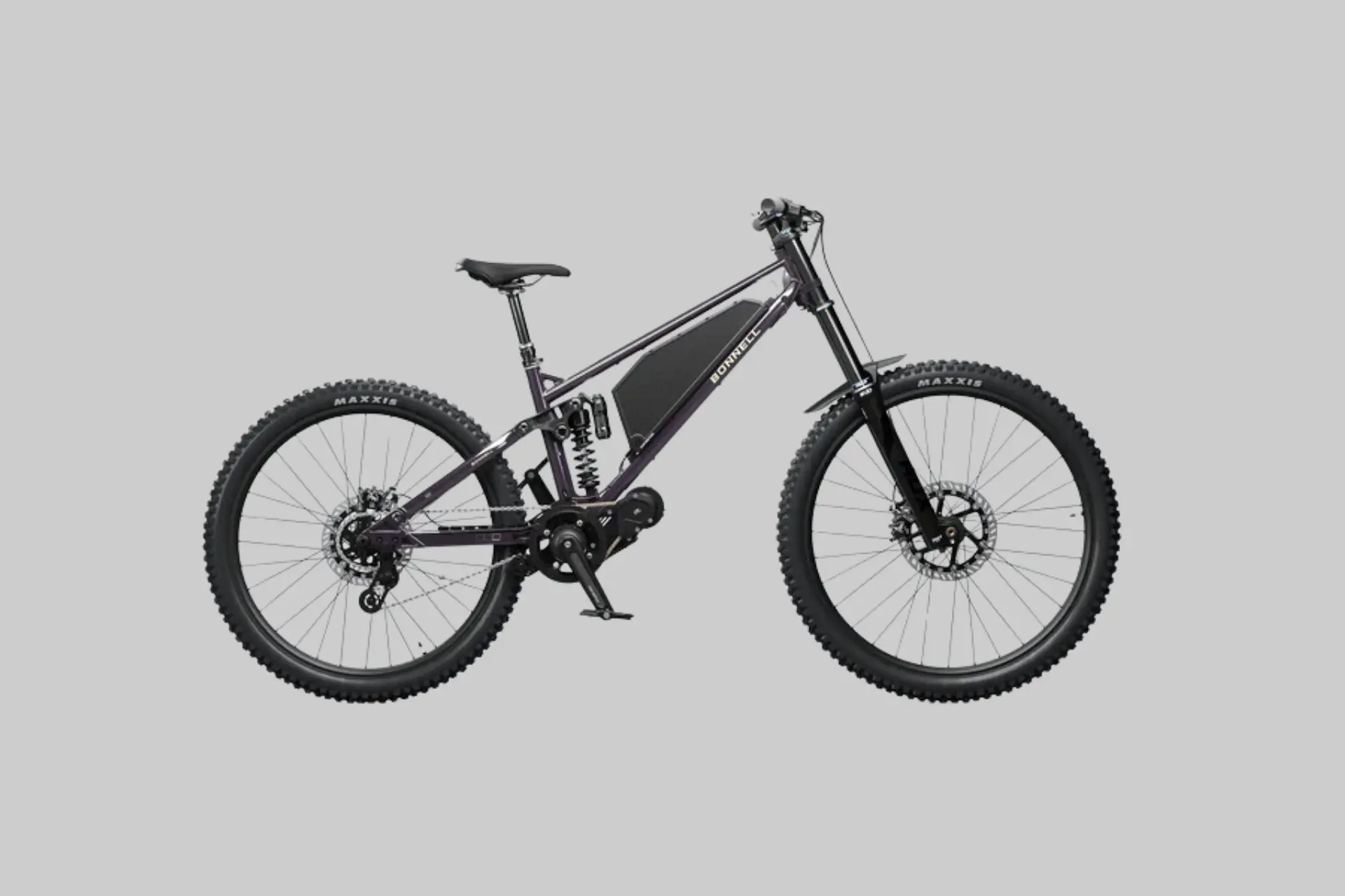A Bonnell 775 MX electric mountain bike being ridden aggressively on a challenging dirt trail, showcasing its powerful motor and full suspension. - Product Review