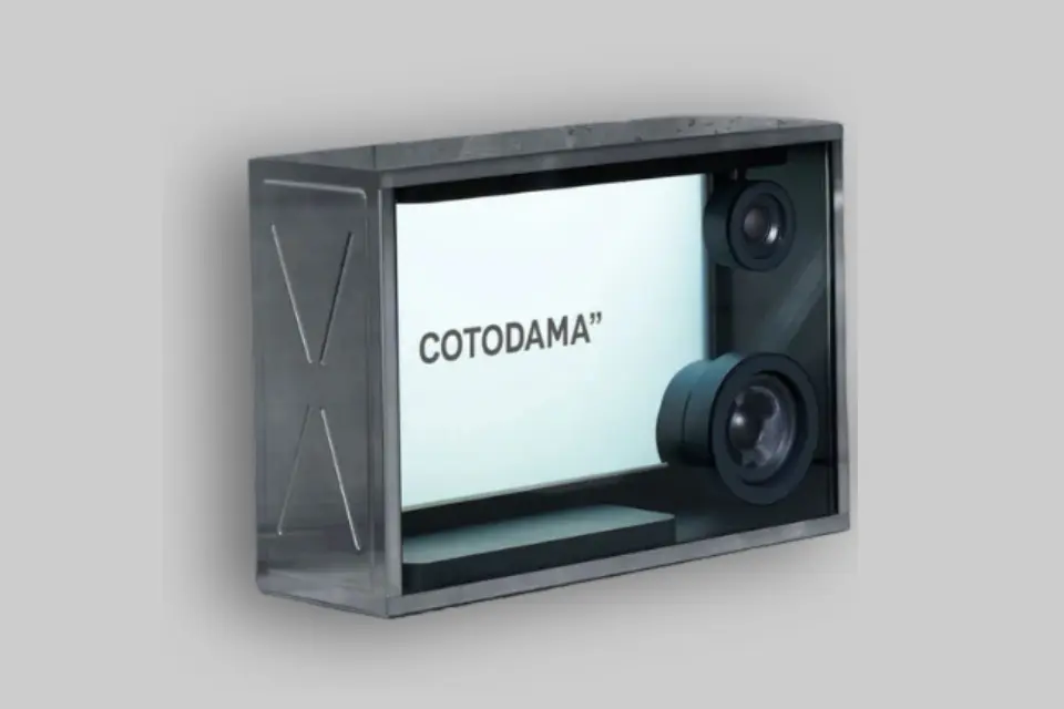 The Cotodama Lyric Speaker Box Military Silver displaying lyrics in motion graphics, set in a modern living room. - Product Review