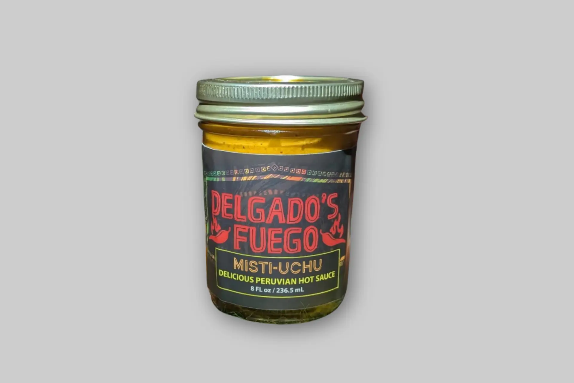 Bottle of Delgado's Fuego Misti-Uchu hot sauce with a vibrant orange label, showcasing rocoto peppers and its Peruvian heritage. - Product Review