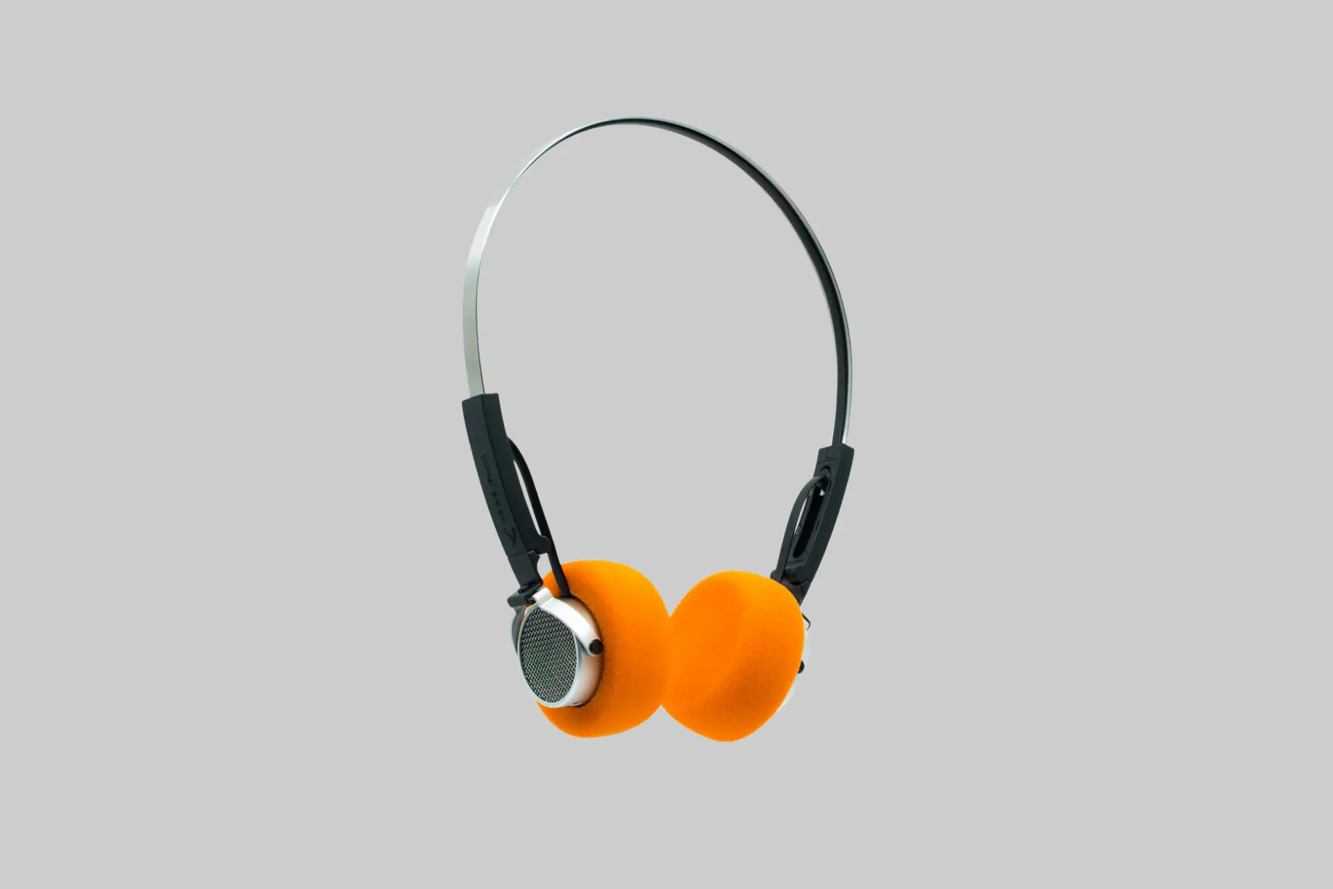 Freddie retro wireless headphones with interchangeable orange, yellow, and black ear cushions.
