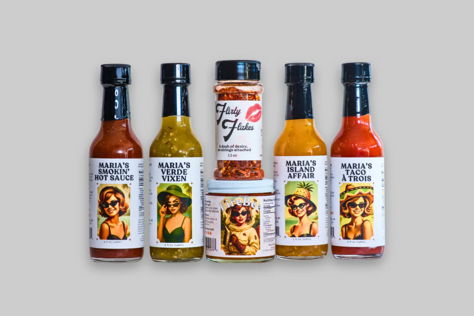 Maria's Sauce Co. The Complete Crush artisan hot sauce gift set, showcasing four hot sauces, spicy honey, and chili flakes. - Product Review