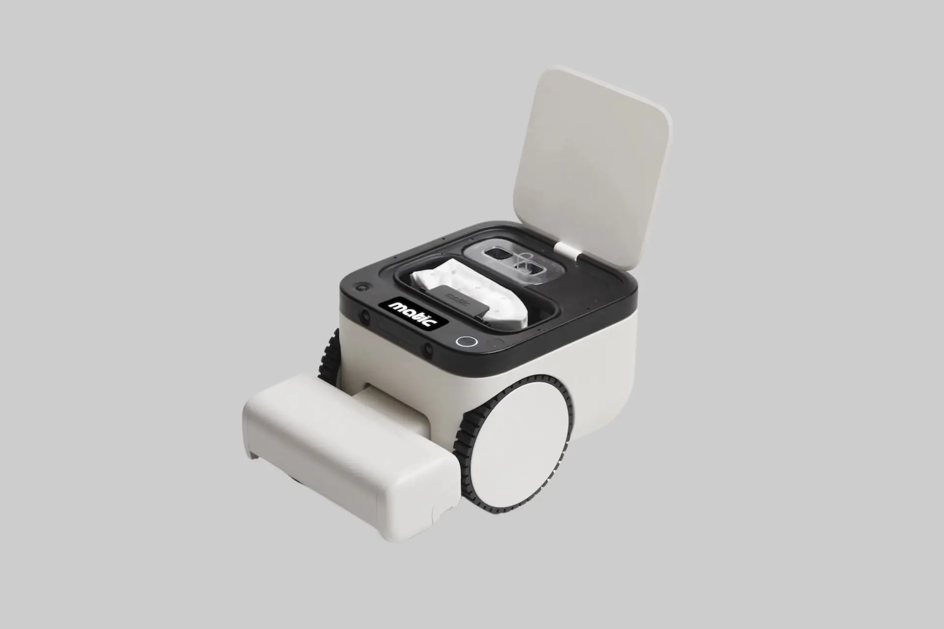 The Matic robot vacuum and mop shown in a living room, with its two front-facing cameras visible and a blanket fort in the background, illustrating its obstacle avoidance capability in a family home.