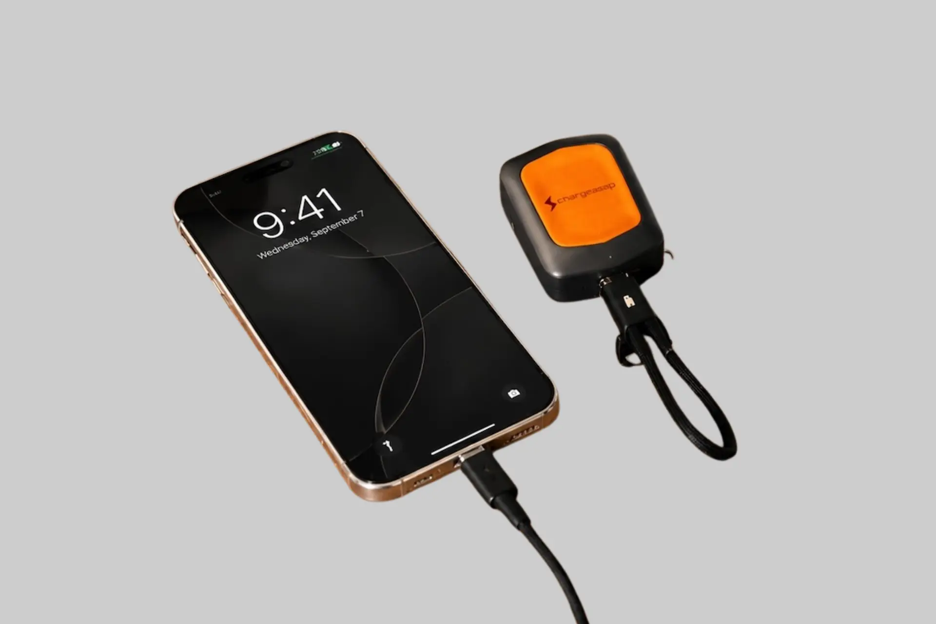 The Miko 30W GaN keychain charger in orange colorway with vegan leather front and gunmetal housing, shown clipped to a keyring alongside a short USB-C cable.