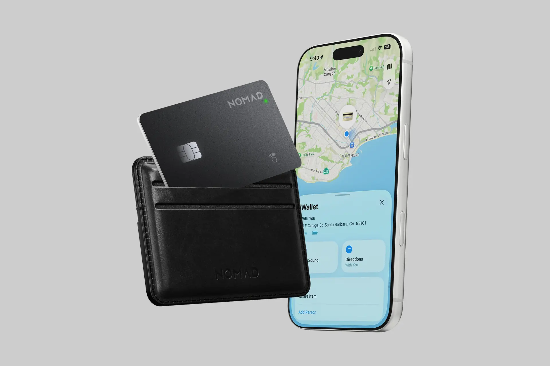 A sleek black Nomad Tracking Card Pro, designed like a credit card, shown discreetly tucked into a leather wallet. - Product Review