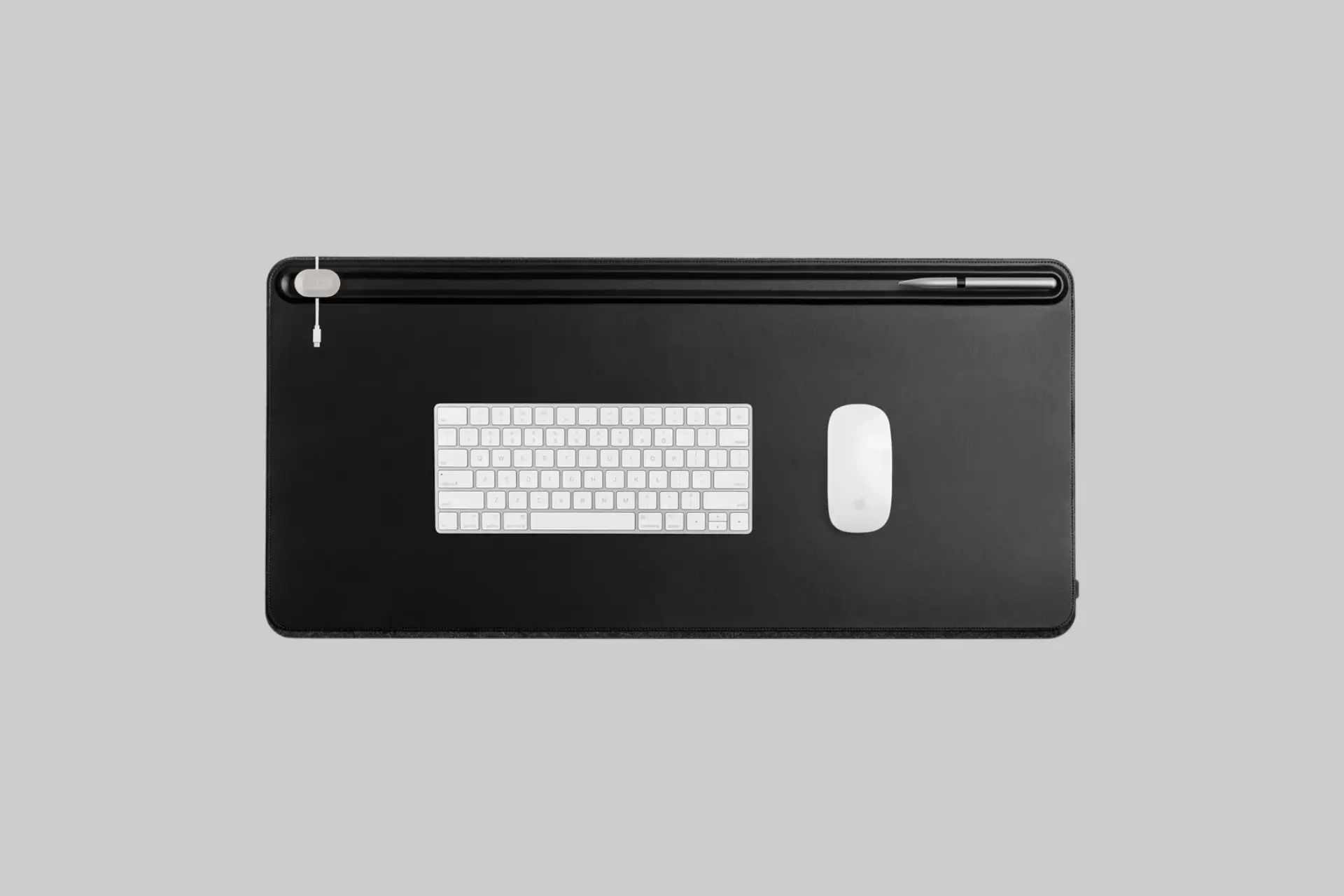 A stylish Orbitkey Desk Mat in black or stone, showcasing the magnetic cable holder, document hideaway, and a clean desk setup. - Product Review