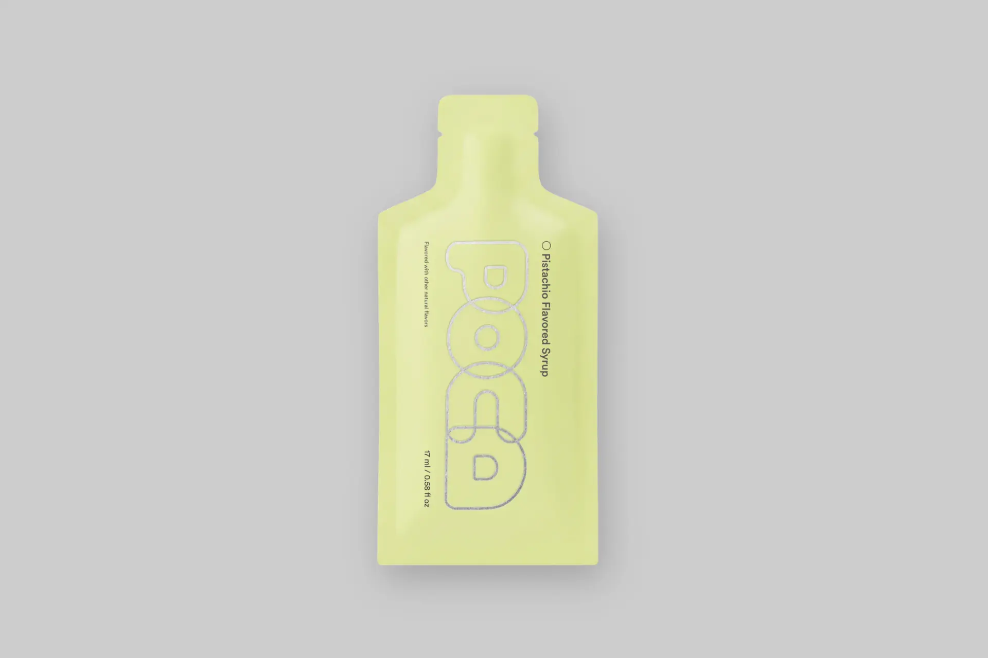 A POCA Pistachio syrup packet next to a steaming cup of matcha latte, showcasing its elegant flavor and healthy benefits. - Product Review