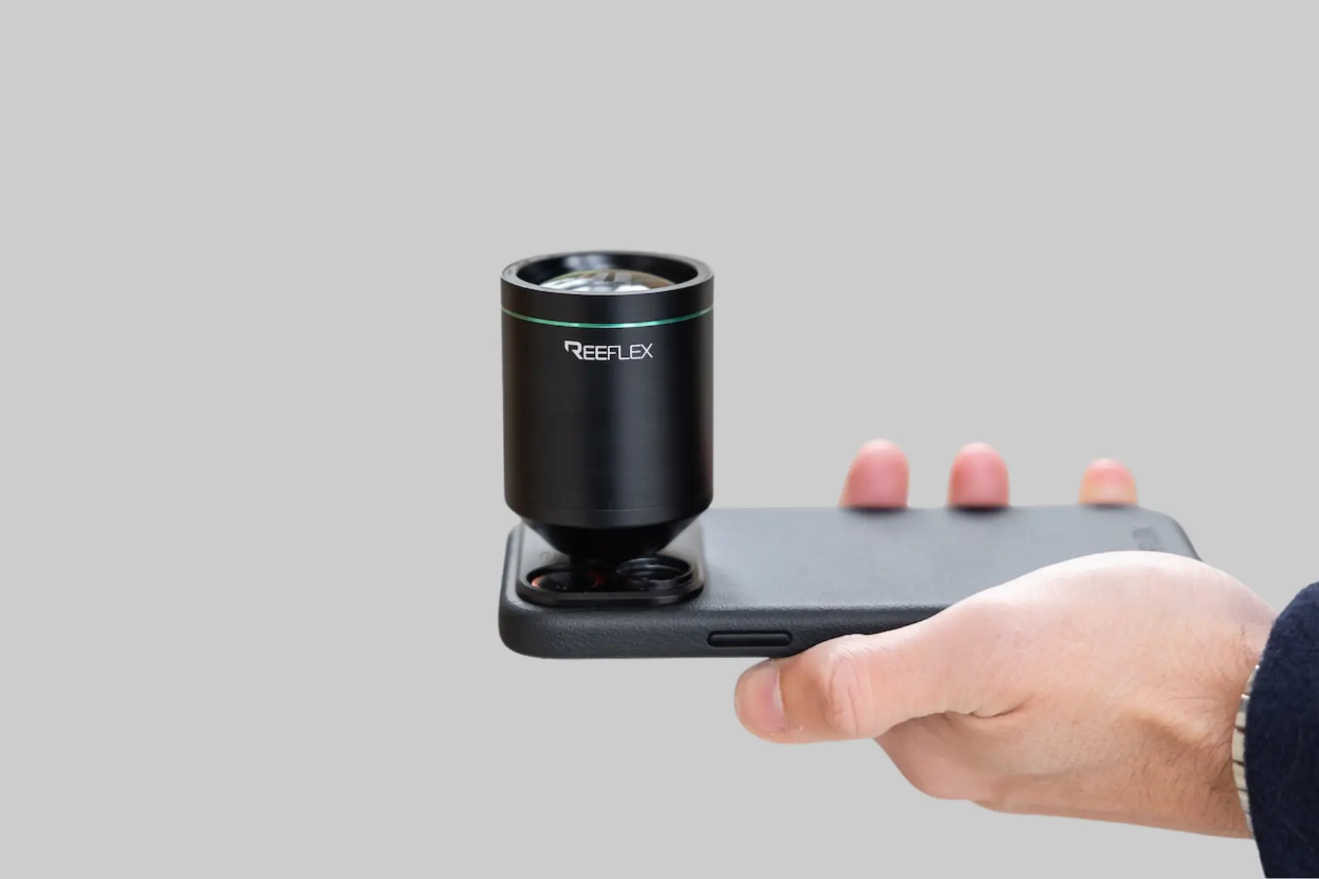 Reeflex Ultra Telephoto Smartphone Lens mounted on an iPhone, showcasing its large aerospace-grade aluminum body and professional telephoto optics for long-range mobile photography. - Product Review