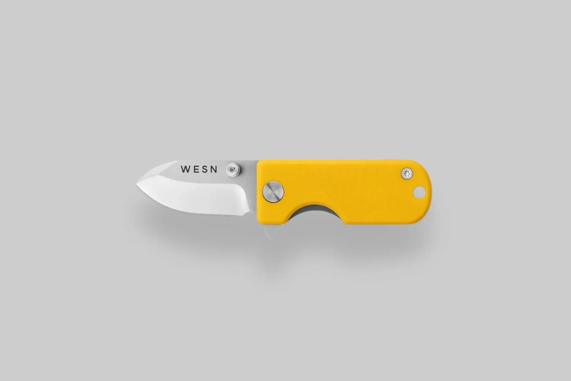 A WESN Microblade knife, open to show its small D2 steel blade and titanium handle, next to a set of keys, illustrating its everyday carry use. - Product Review