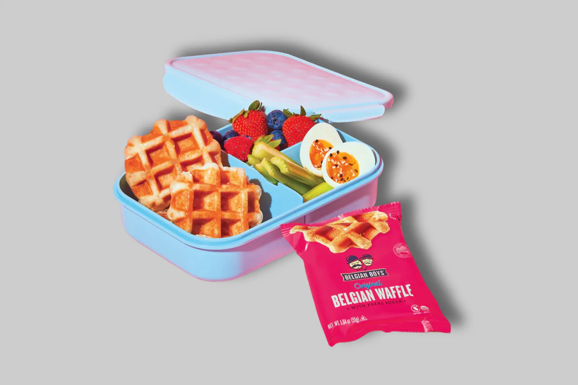 A stack of golden-brown Belgian Boys Original Belgian Waffles, some with visible pearl sugar, ready for serving with berries and syrup. - Product Review
