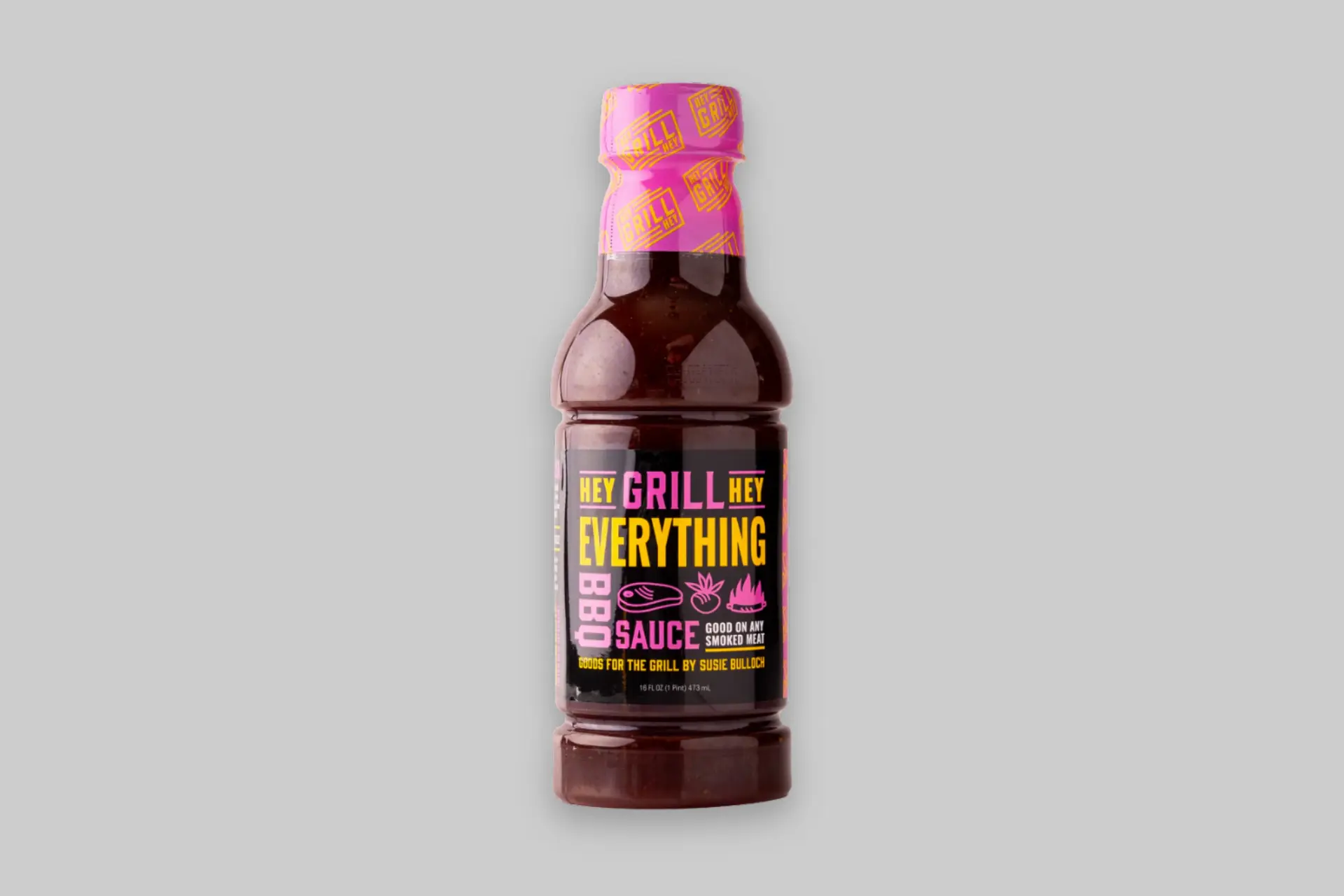 A bottle of Hey Grill Hey Everything BBQ Sauce with a rich, dark color, next to grilled chicken and ribs, showcasing its versatility for barbecue dishes. - Product Review