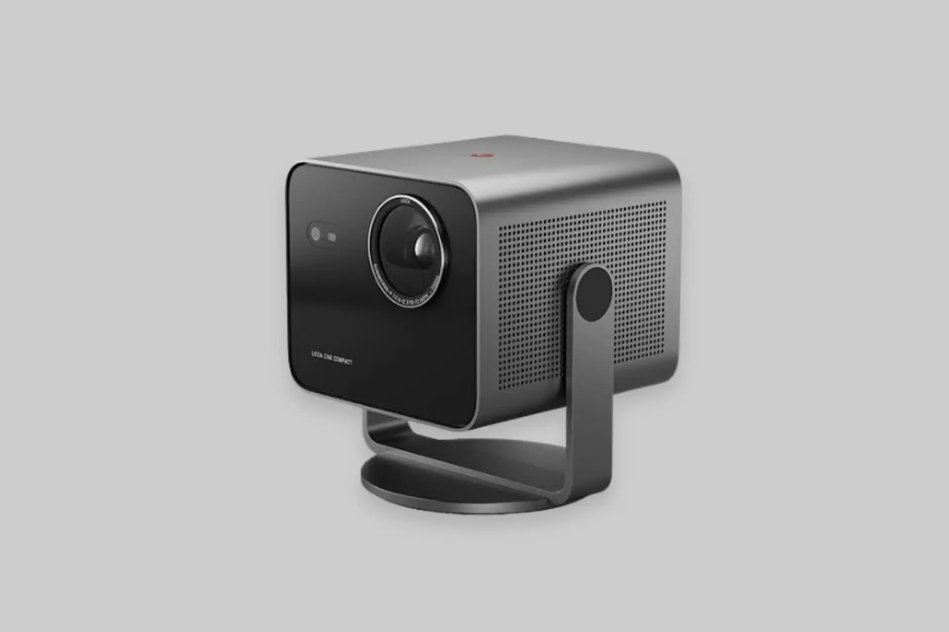 Leica Cine Compact 1 portable 4K laser projector with aluminum body projecting a large home theater image.
