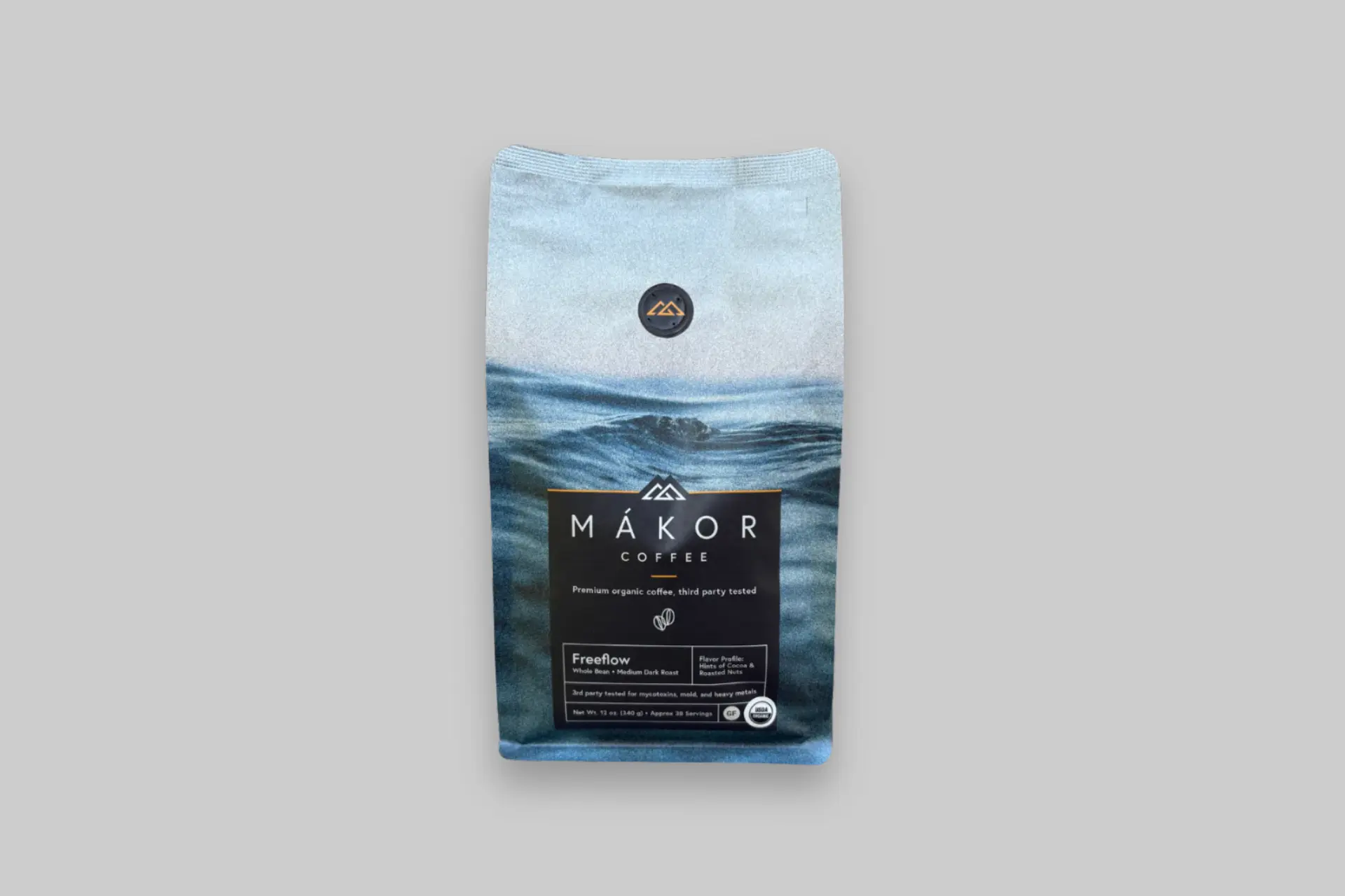 Mákor Freeflow Organic Whole Bean coffee in a resealable bag with premium USDA Organic Arabica beans and a freshly brewed cup of coffee.