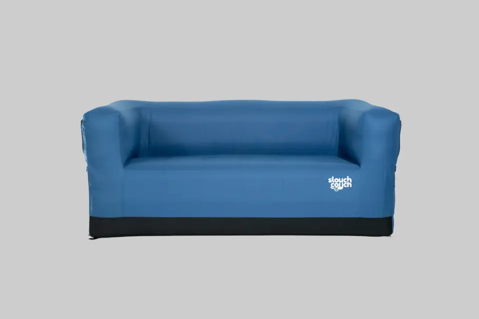 A couple relaxing comfortably on a Slouch Couch portable inflatable loveseat outdoors at a campsite. - Product Review
